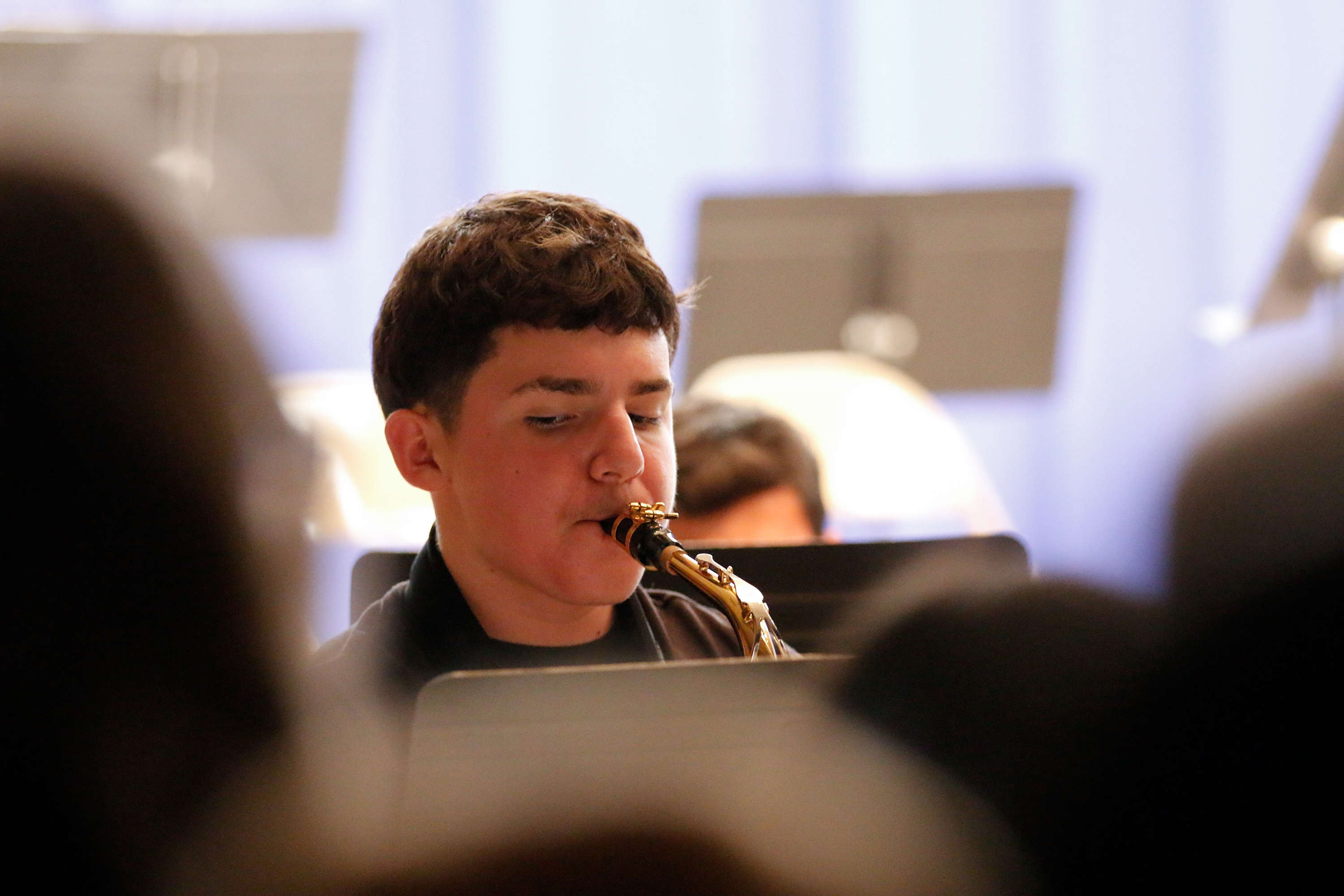 A boy plays alto saxophone