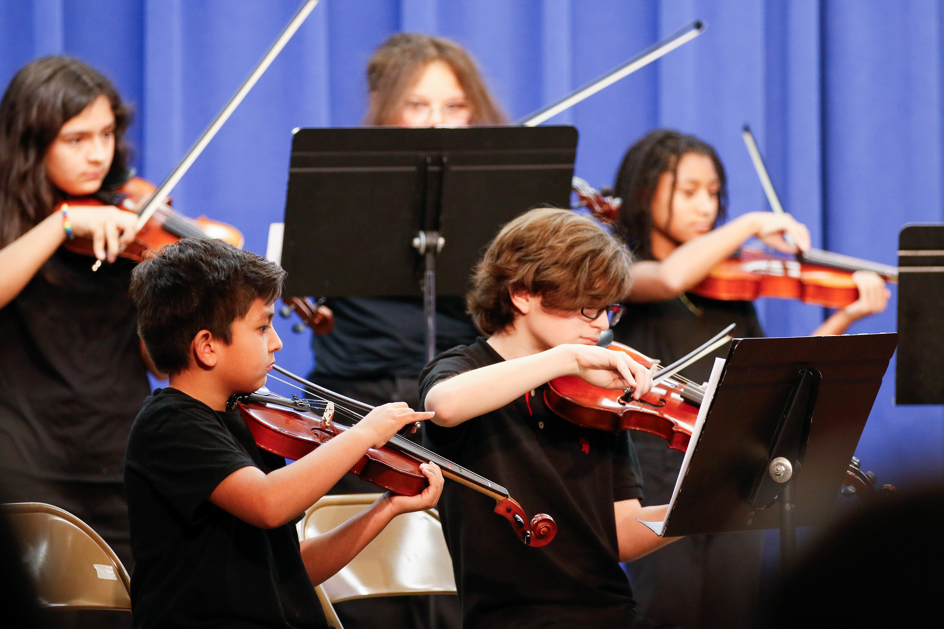 A group of students play violin