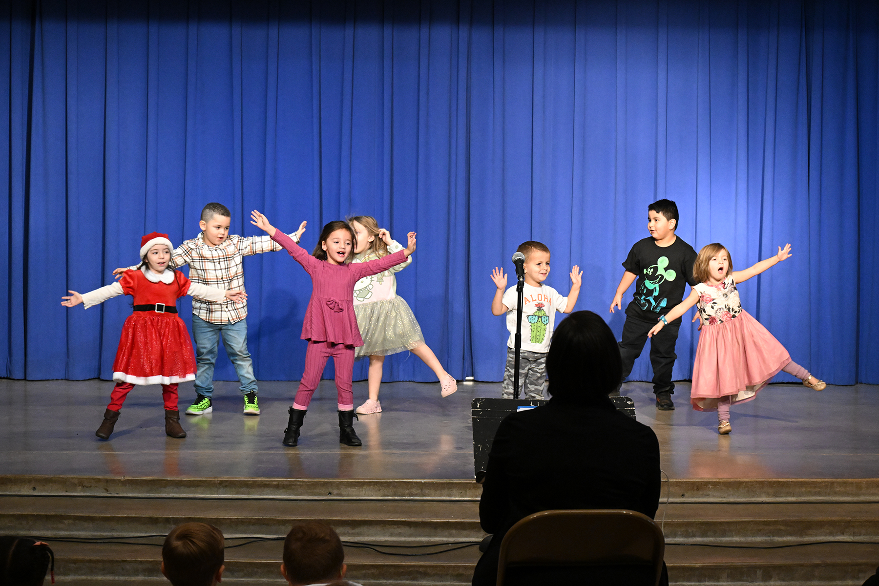 Students dance around on stage