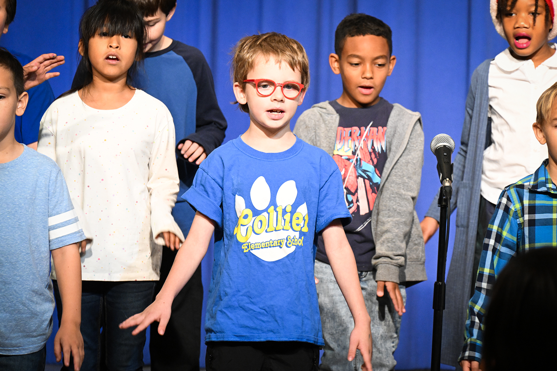 Students sing on stage