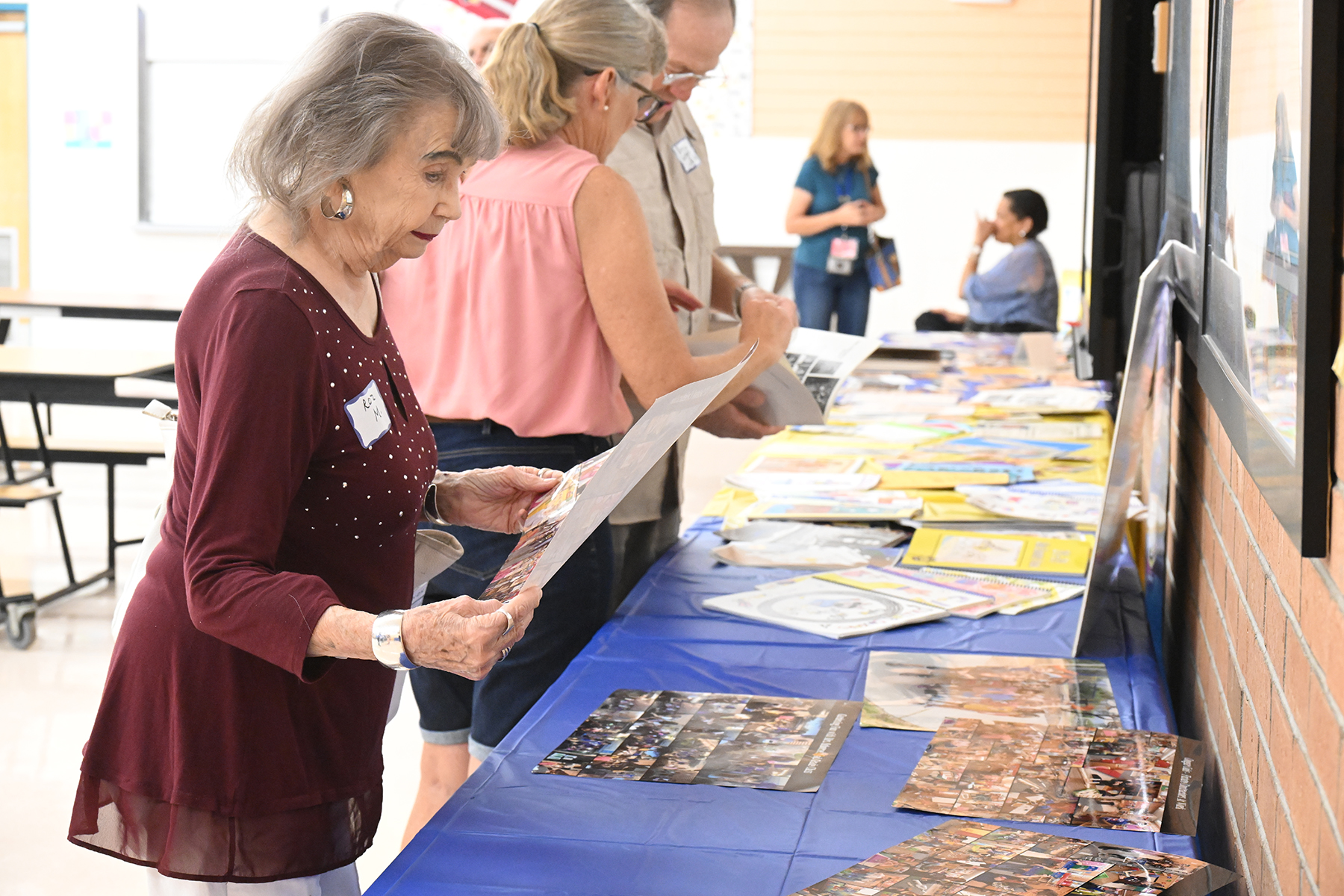 A woman looks through old photos of the school's history