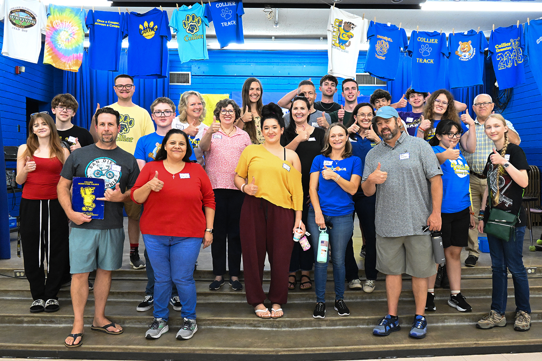 A group photo of open house attendees, including staff and former students