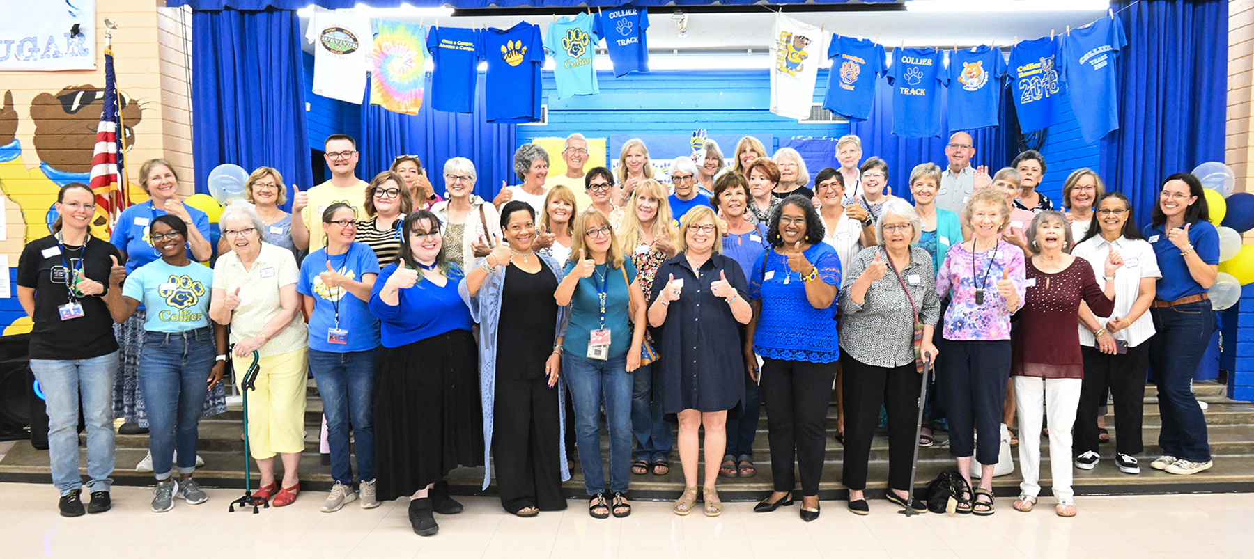 Collier staff and community members pose for a group photo during the open house