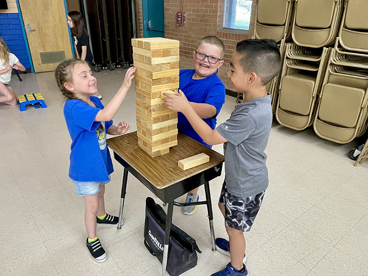 Three students play Jenga