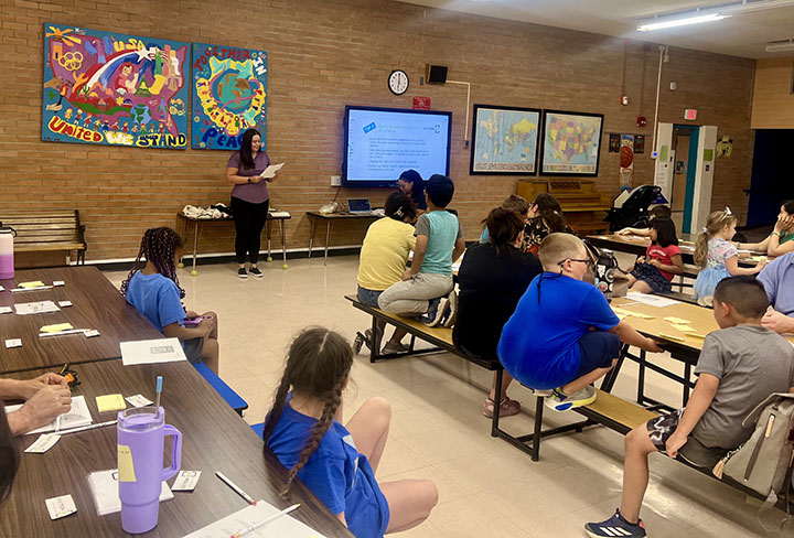 Students watch a presentation in the cafeteria