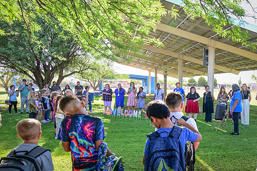 Students gather on the field outside for the opening day assembly
