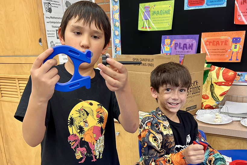 Two boys play with magnets