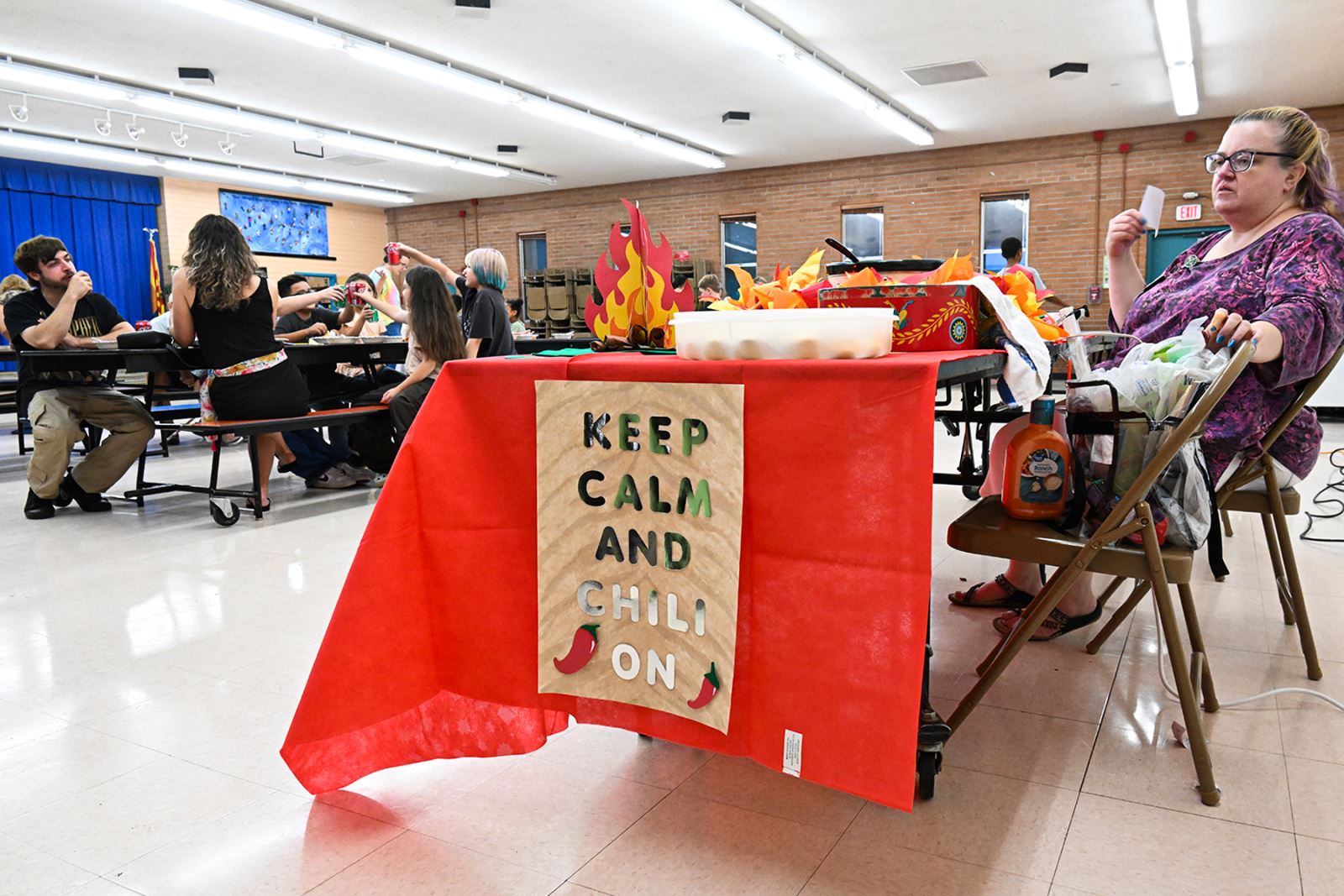 A table is decorated with a Keep Calm & Chili On sign and flames.