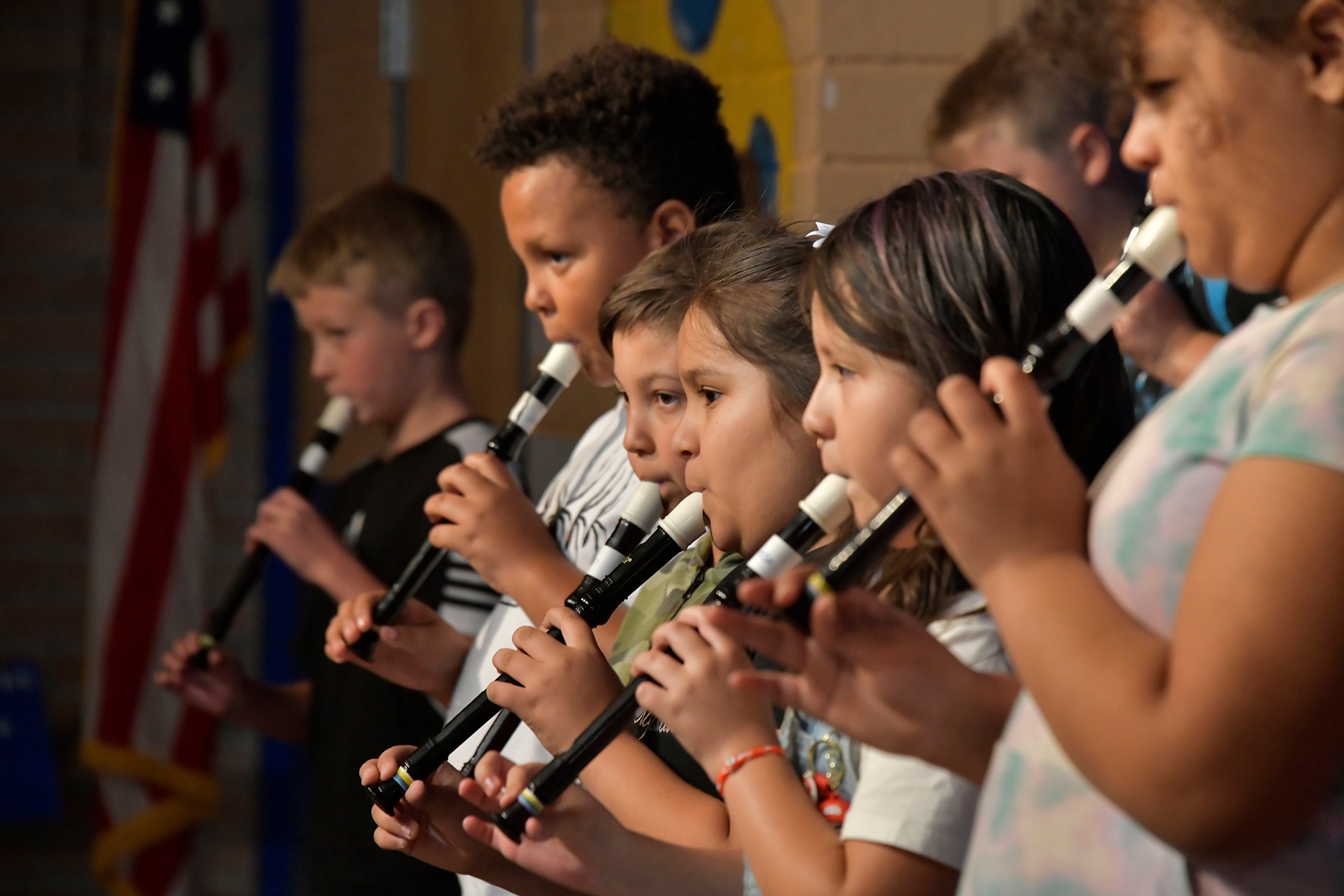 Closeup of students lined up playing their recorders