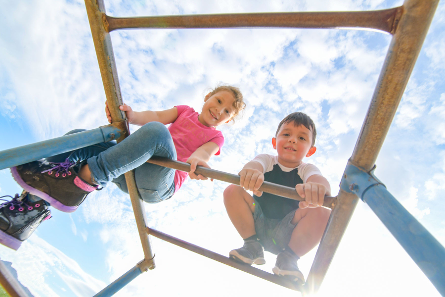 Children playing on high bars.